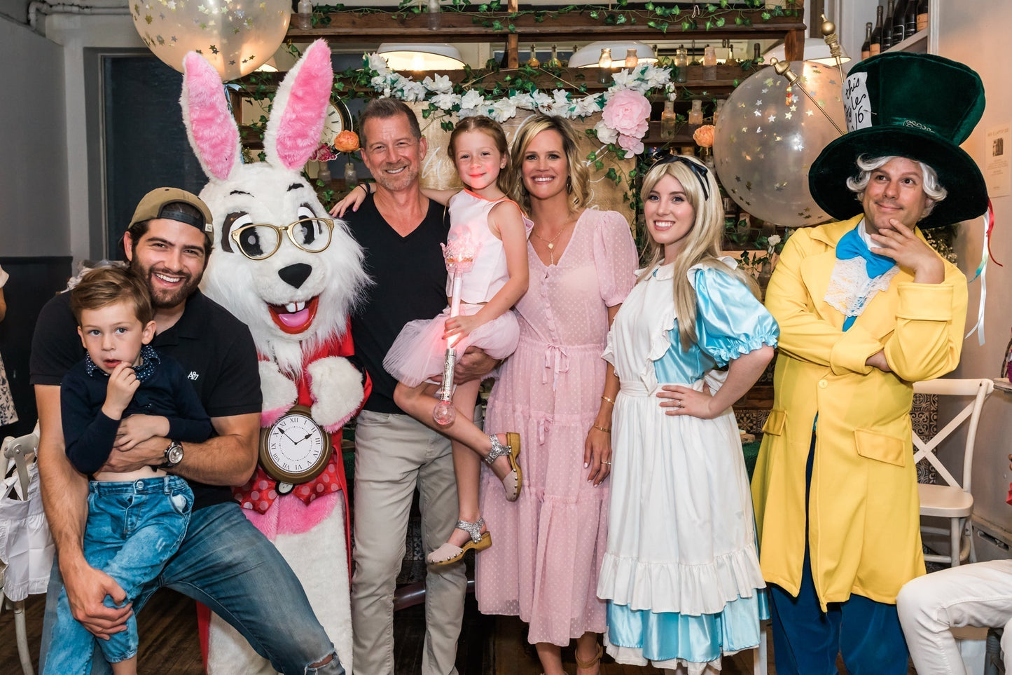 Birthday girl celebrating with Alice in Wonderland characters at maman, capturing a magical storybook moment