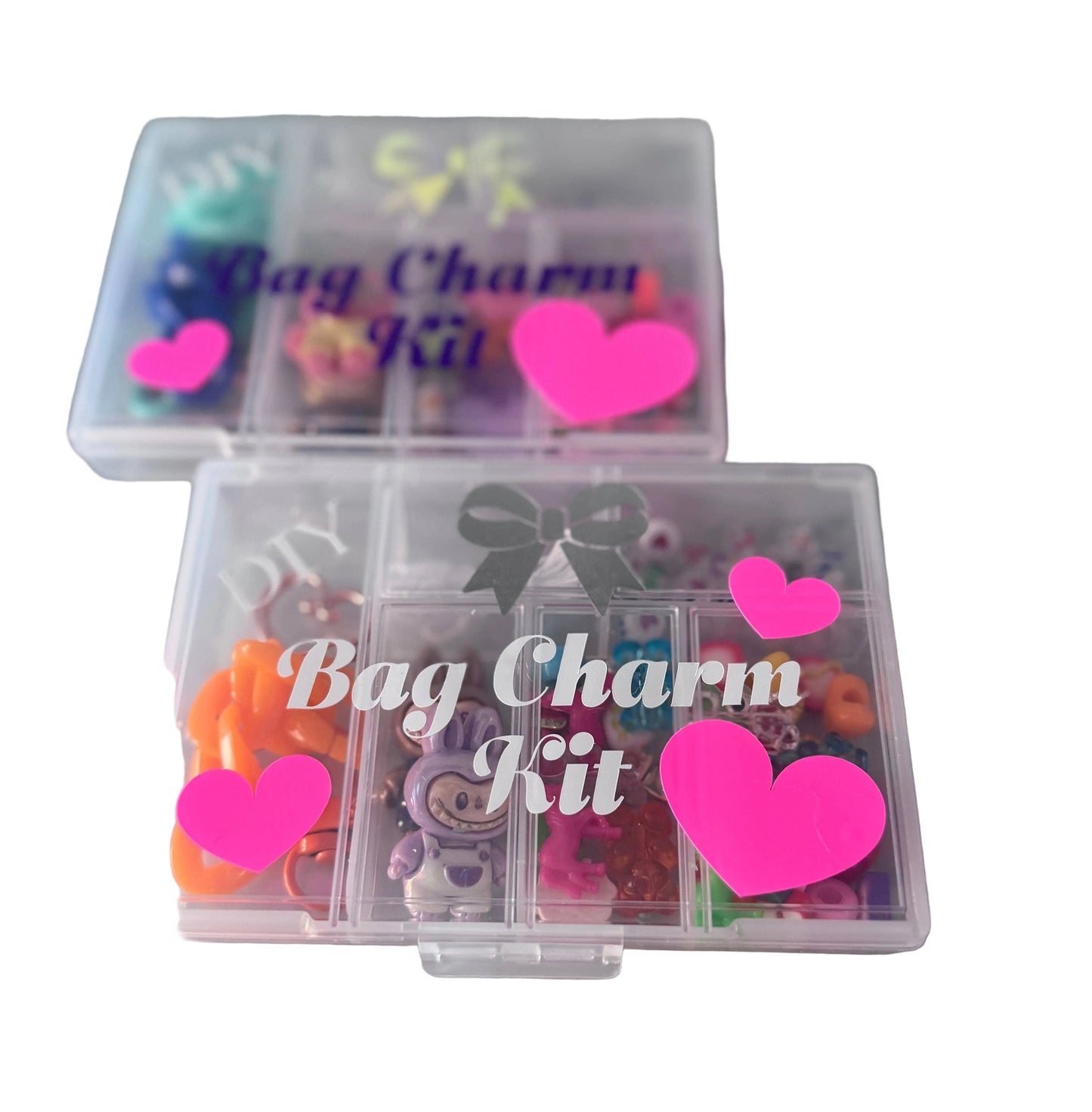 Bag Charm Kit with various charms in a clear plastic box on a marble surface