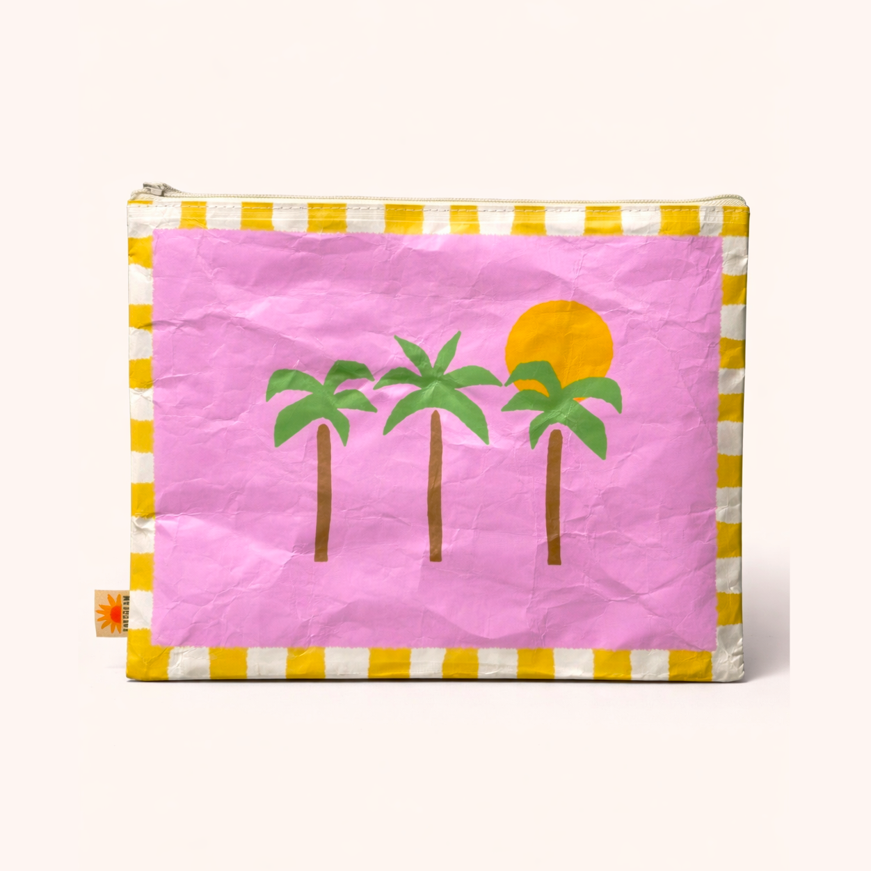 Pink pouch with palm tree and sun design on a white background