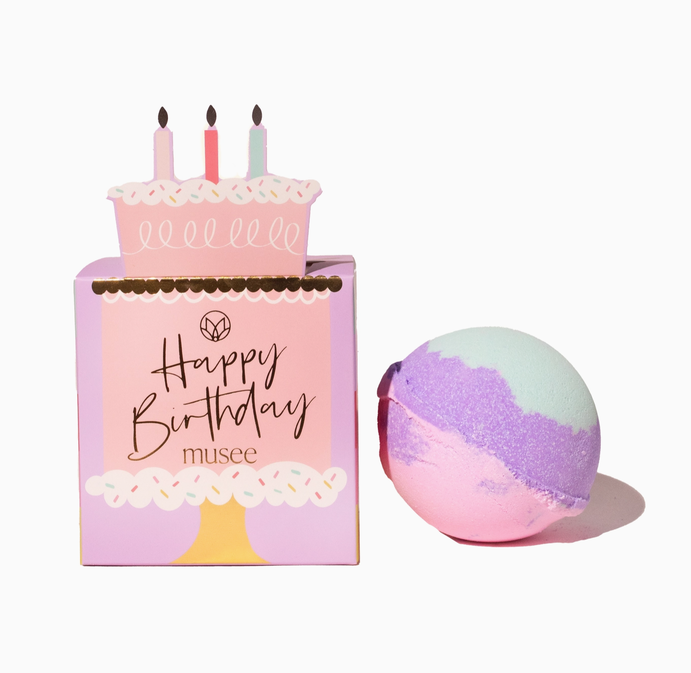 Birthday-themed bath bomb with packaging and a colorful bath bomb on a white background