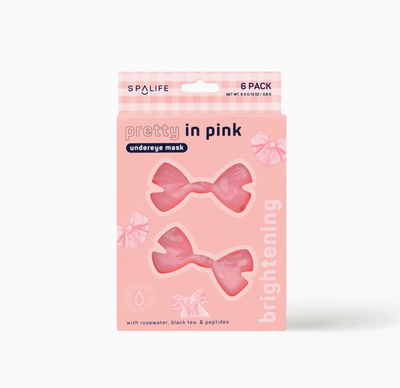 Packaging of Pretty in Pink brightening undereye masks with two masks visible through the transparent window, designed in a bow shape on a pink background.