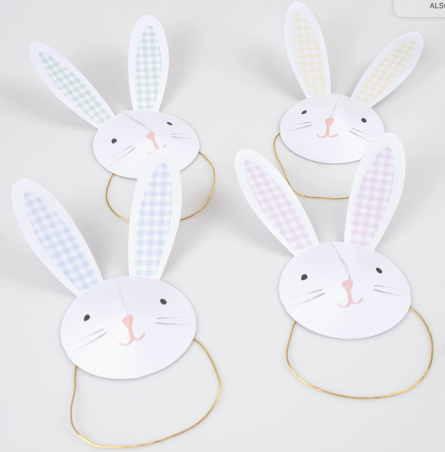 Four bunny-shaped paper plates with ears on a white background
