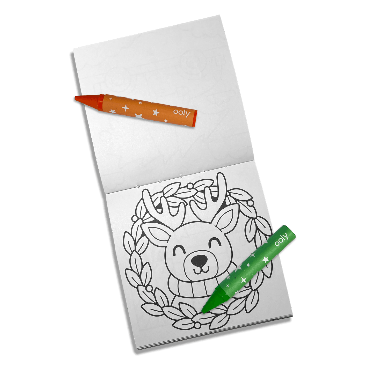 Coloring book with a reindeer design and two markers on a green background