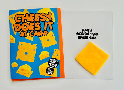 Cheesy-themed product packaging with text and a block of cheese on a white background