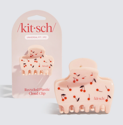 A medium-sized hair clip with a cherry print design, made from recycled plastic, packaged in a clear plastic packaging with the brand name 'kitsch' visible.