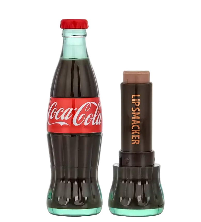 A novelty lip smacker shaped like a Coca-Cola glass bottle, shown closed with a red cap and label, next to an open version of the same lip smacker revealing a brown stick, on a white background.