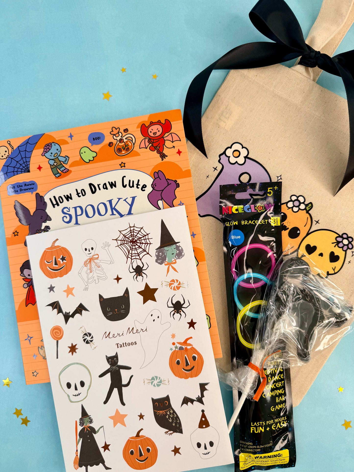 Cute Halloween boo bag for kids with a spooky drawing book, temporary tattoos, glow bracelets, ghost lollipop, and canvas ghost bag.