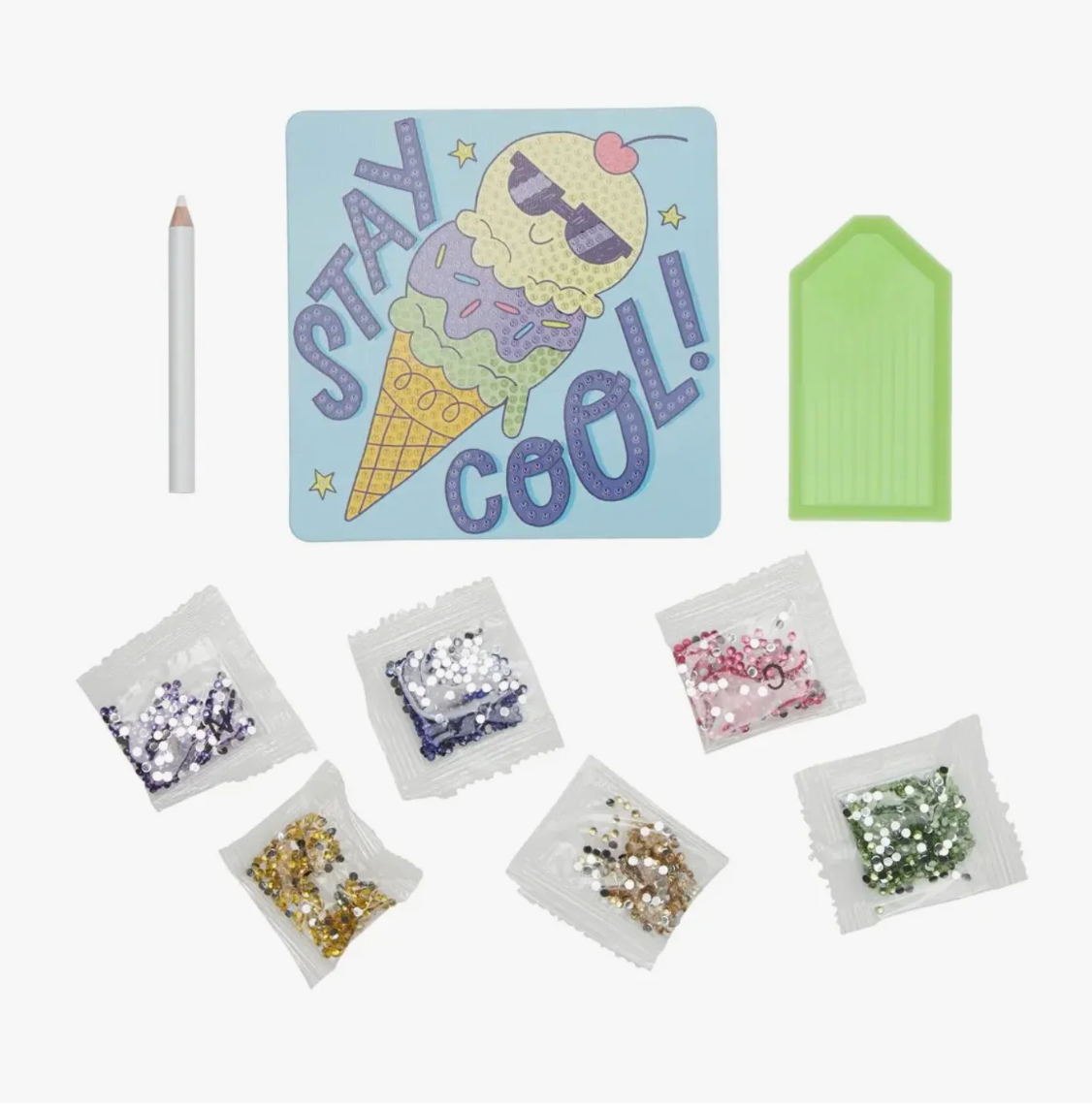 Craft kit with ice cream-themed card, sequins, and tools on a white background