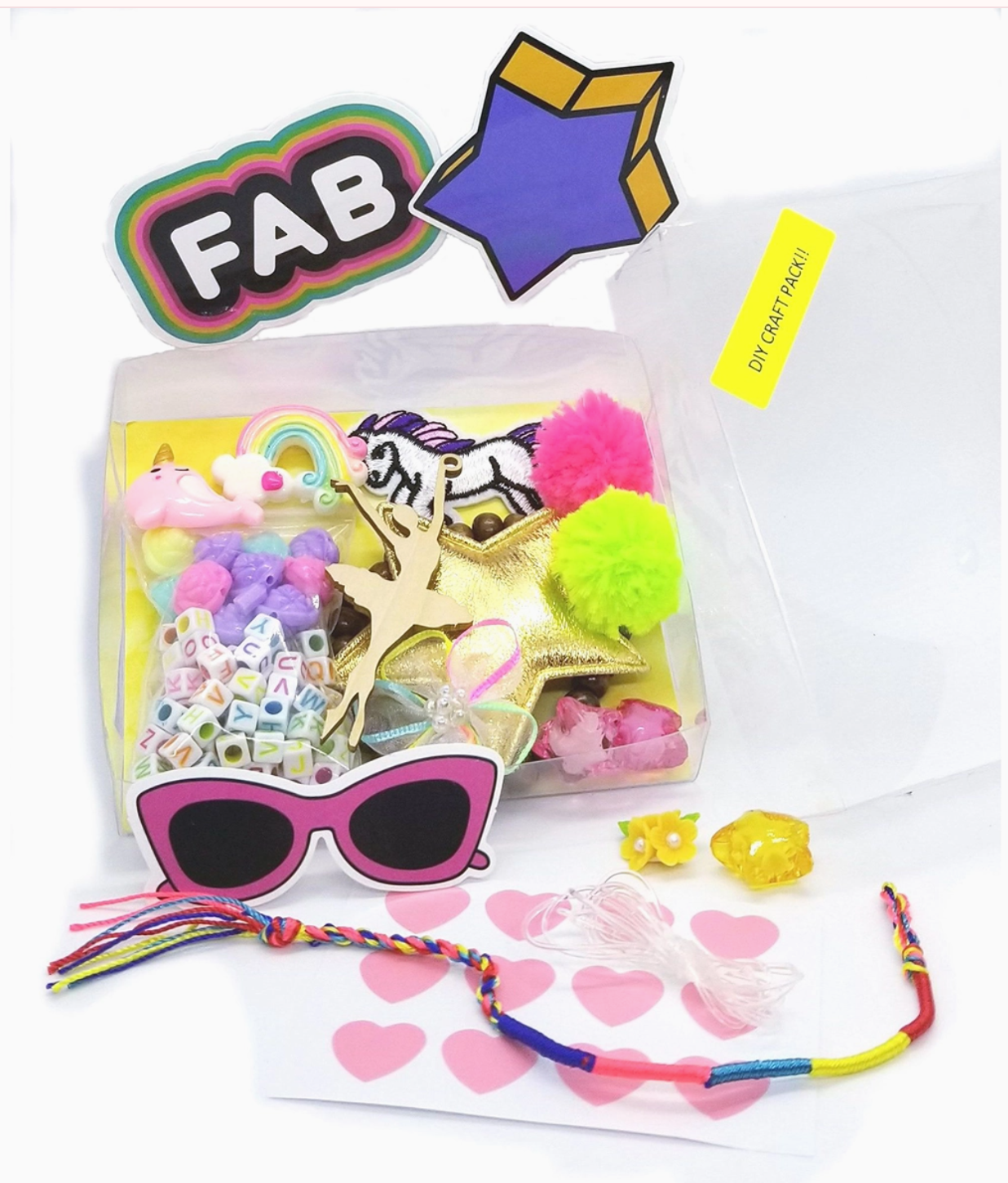 Colorful craft kit with sunglasses, beads, and decorative items on a white background
