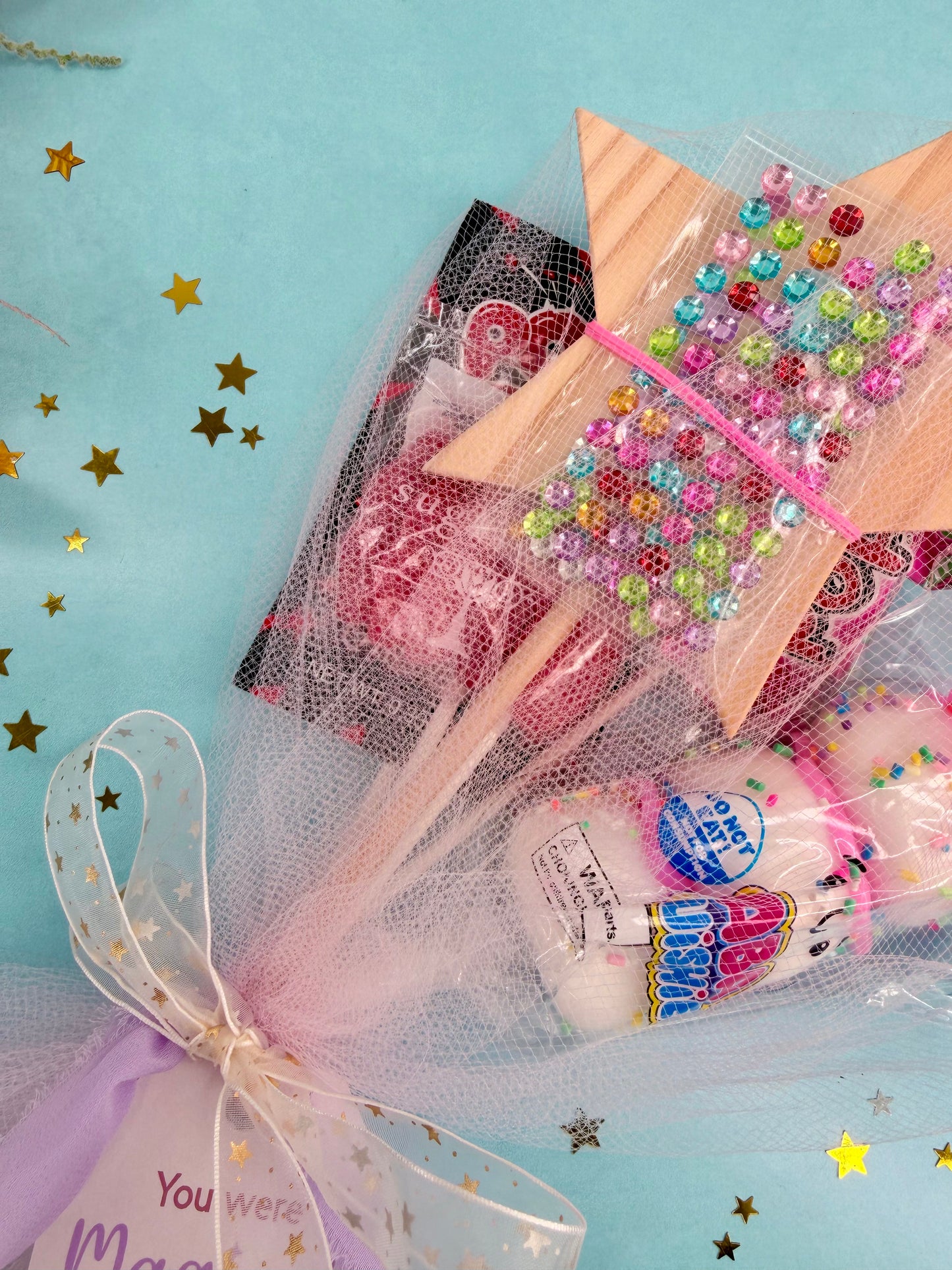 Bouquet of lollipops with decorative ribbons on a light blue background