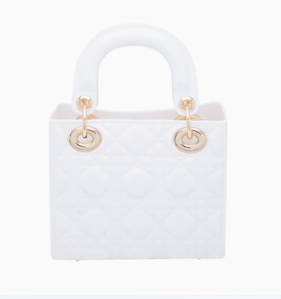 White handbag with gold handles on a white background