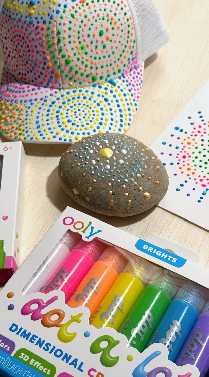 Ooly dot-a-lot dimensional coloring set with colorful markers and dotting tools on a wooden surface.