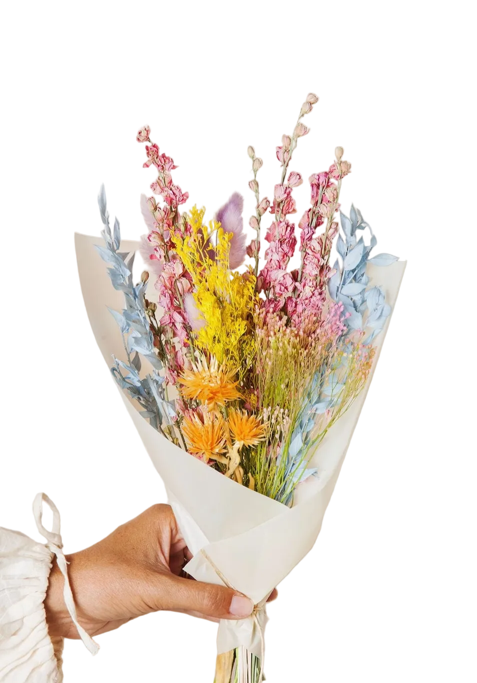 Bouquet of colorful dried flowers held by a person against a neutral background
