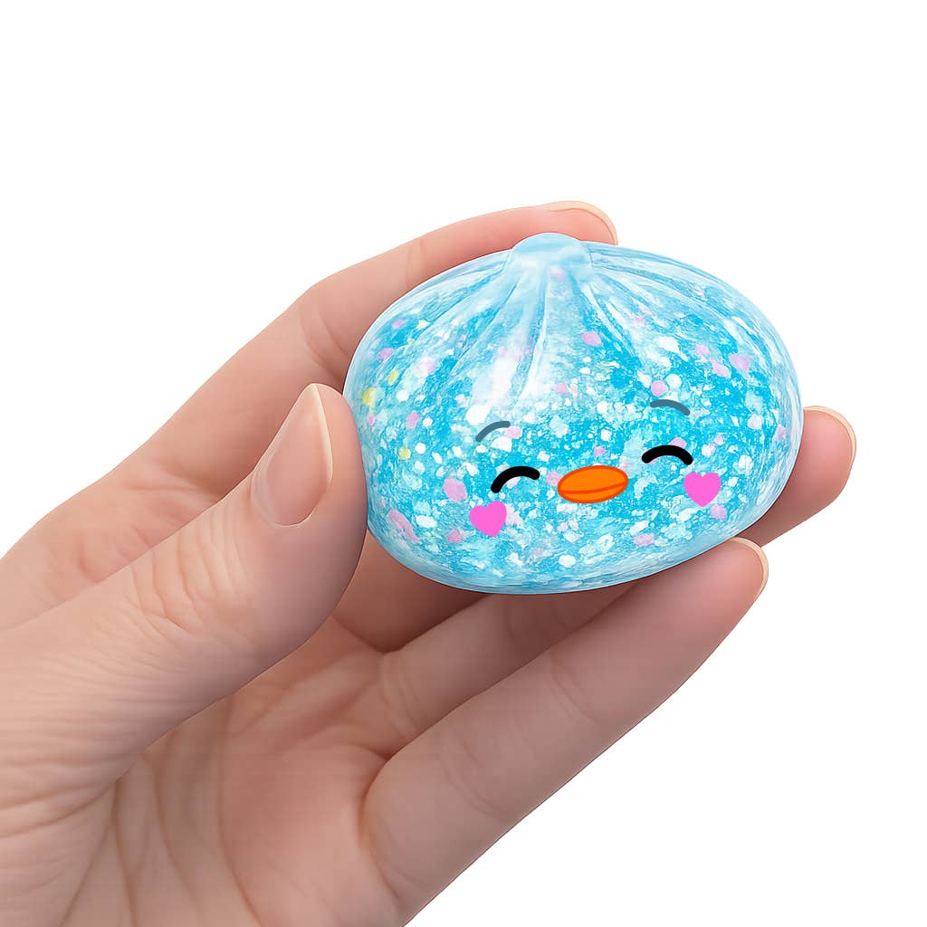 Hand holding a blue glittery ball with a face design on a white background