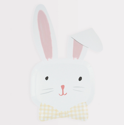White bunny face with pink ears and bow tie on a light gray background