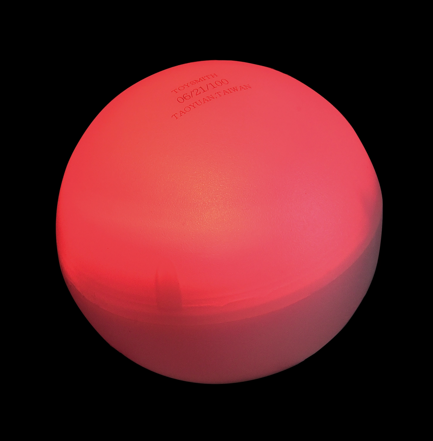 Red ball with visible branding on a black background