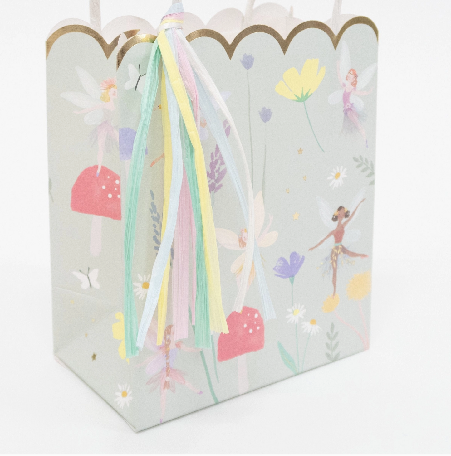 Gift bag with fairy design and ribbons on a white background