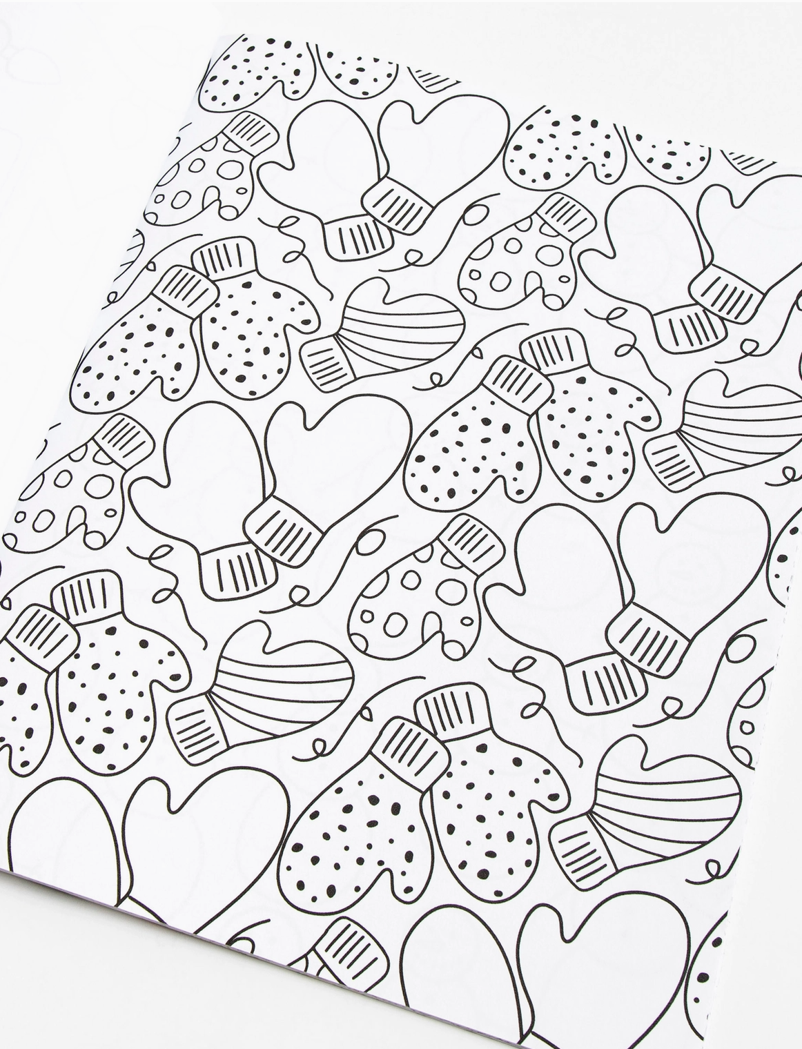 Coloring page with black and white pattern of mittens and hearts.