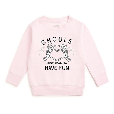 A light pink long-sleeve crewneck sweatshirt featuring a black graphic print of skeleton hands forming a heart shape with the text 'GHOULS JUST WANNA HAVE FUN' on a plain white background.