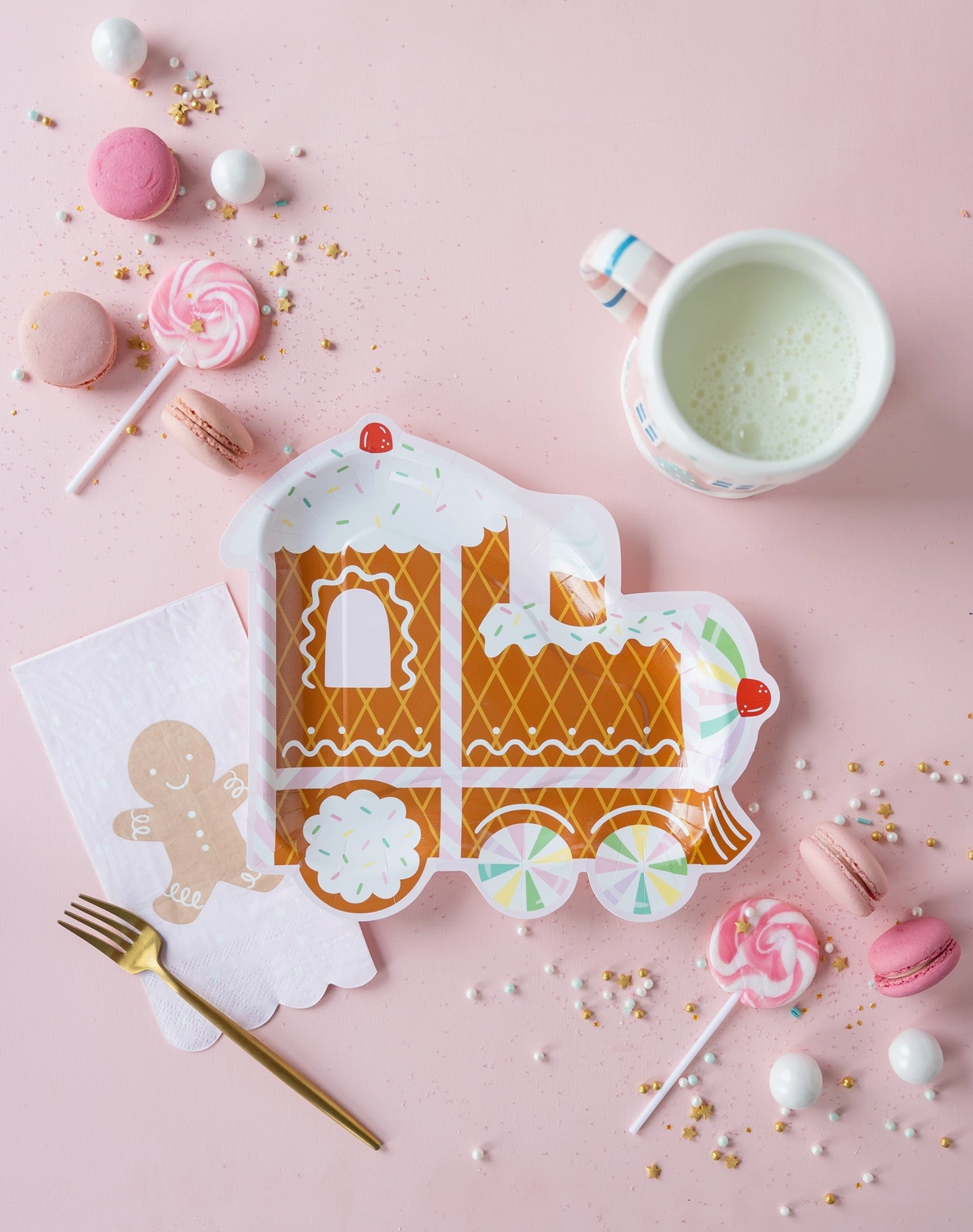 Gingerbread train plate with decorative elements on a pink background