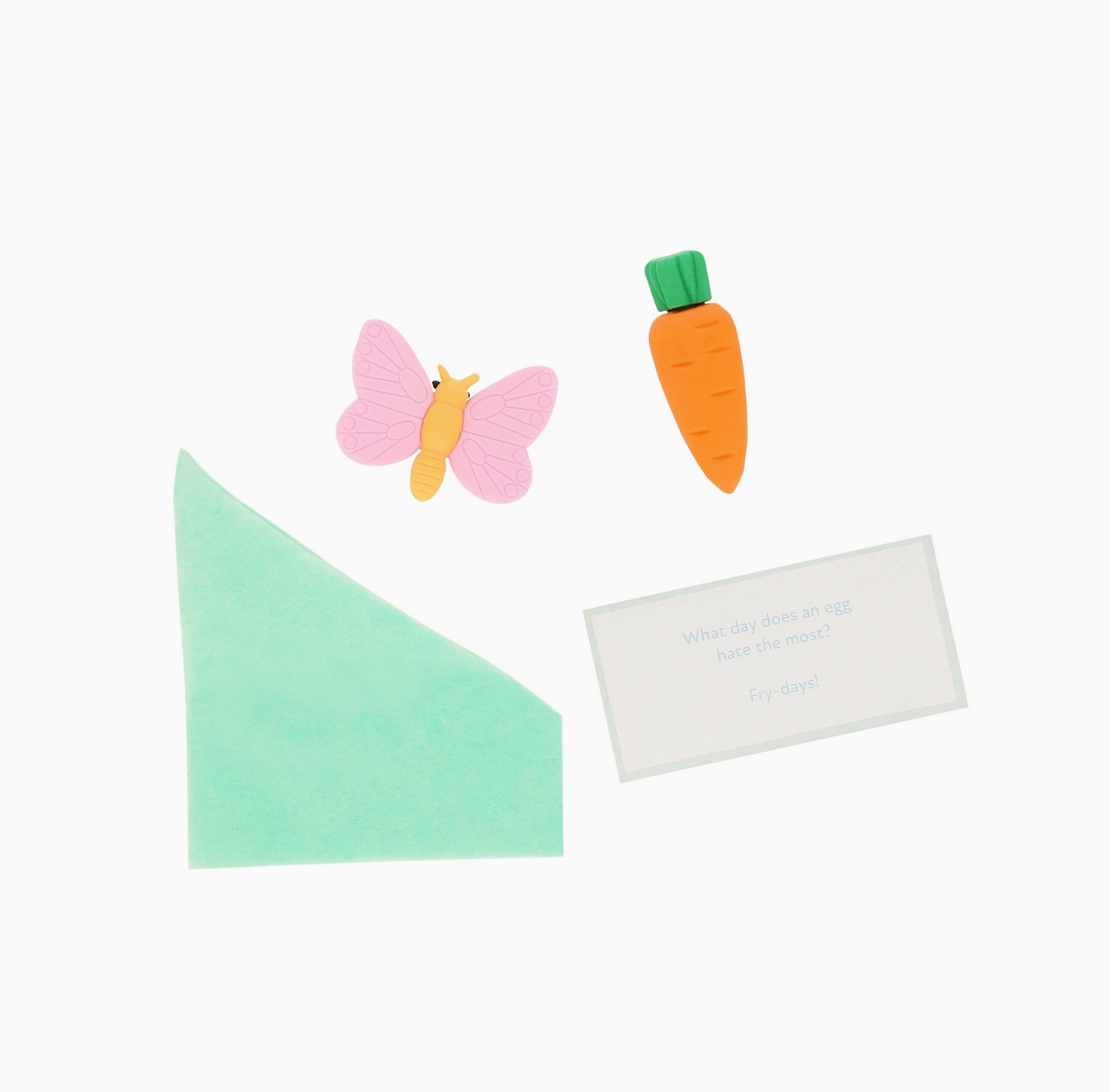 Butterfly, carrot, and triangle-shaped items on a white background