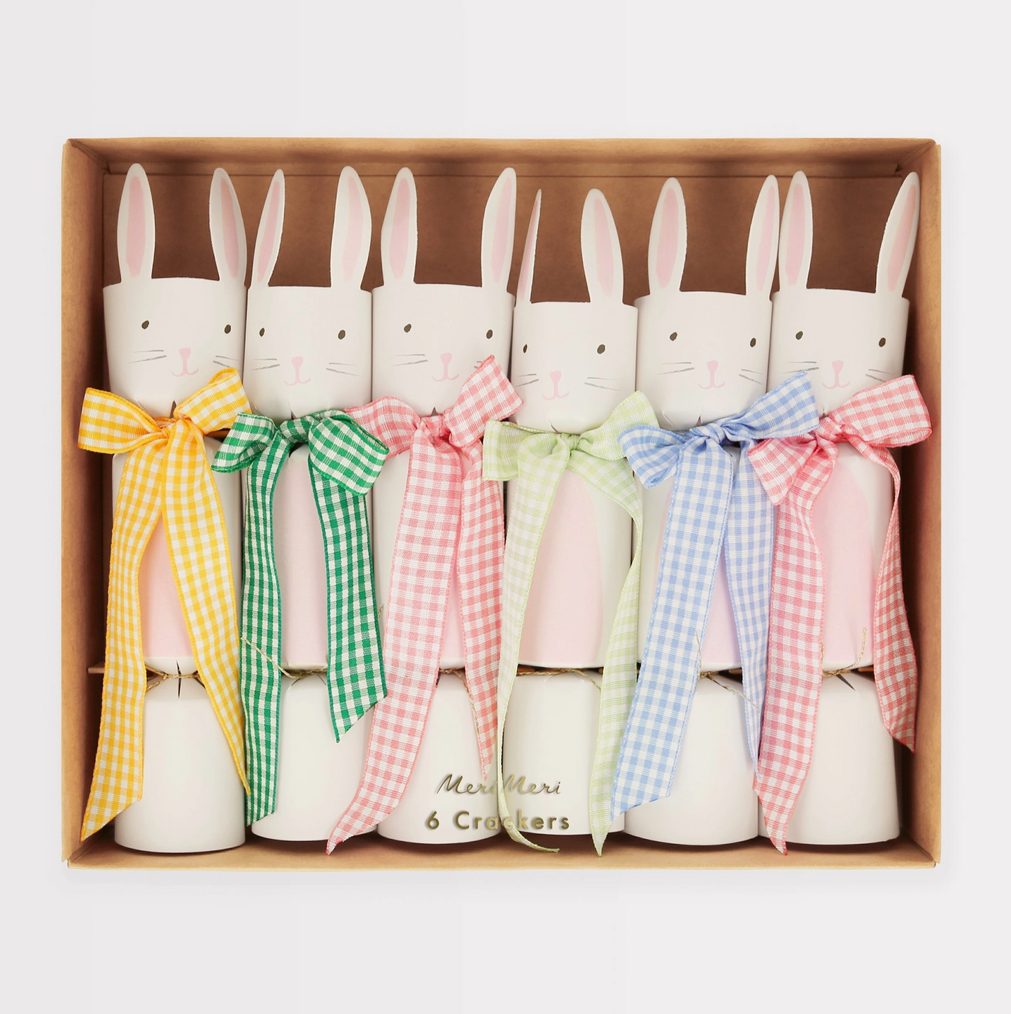 Set of six bunny-shaped candles with colorful bows in a box