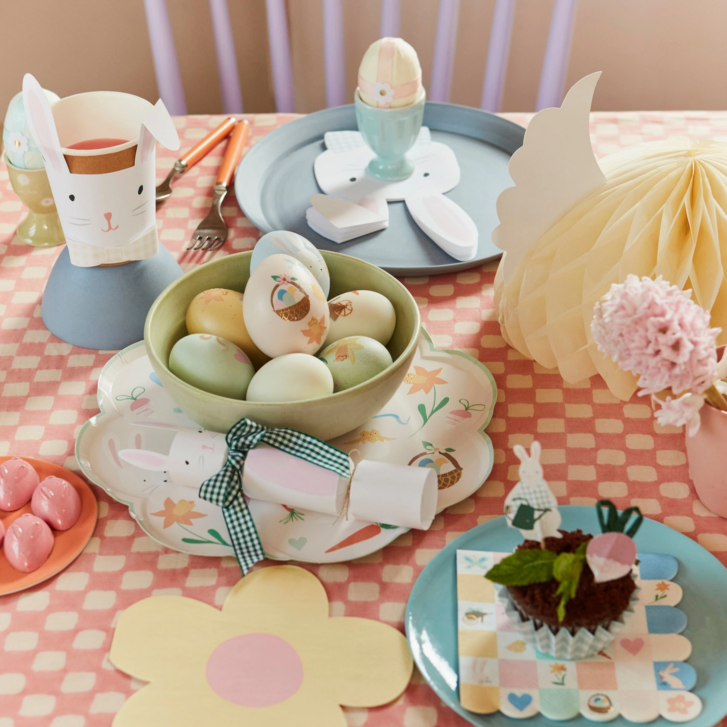 Easter-themed table setting with pastel colors and decorative elements.