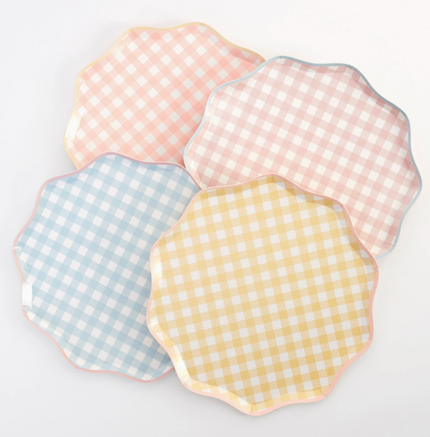 Four checkered plates in pink, blue, and yellow on a light gray background
