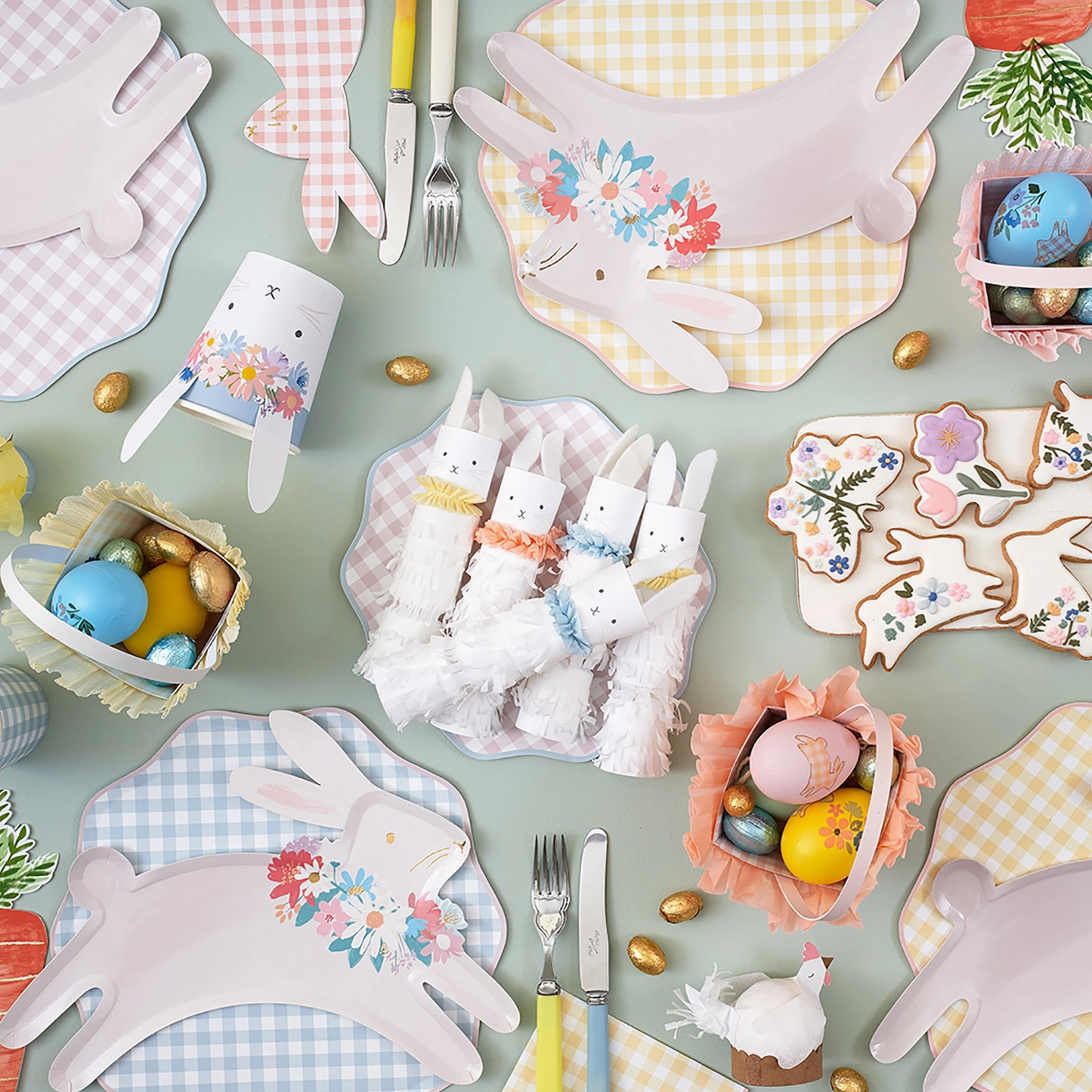 Easter-themed table setting with bunny plates, napkins, and decorative eggs on a light green background.