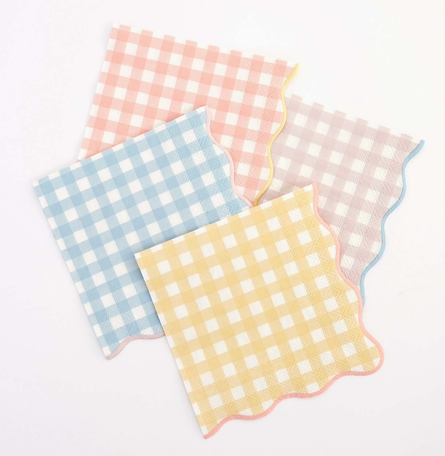 Four checkered napkins in pink, blue, yellow, and white on a light gray background
