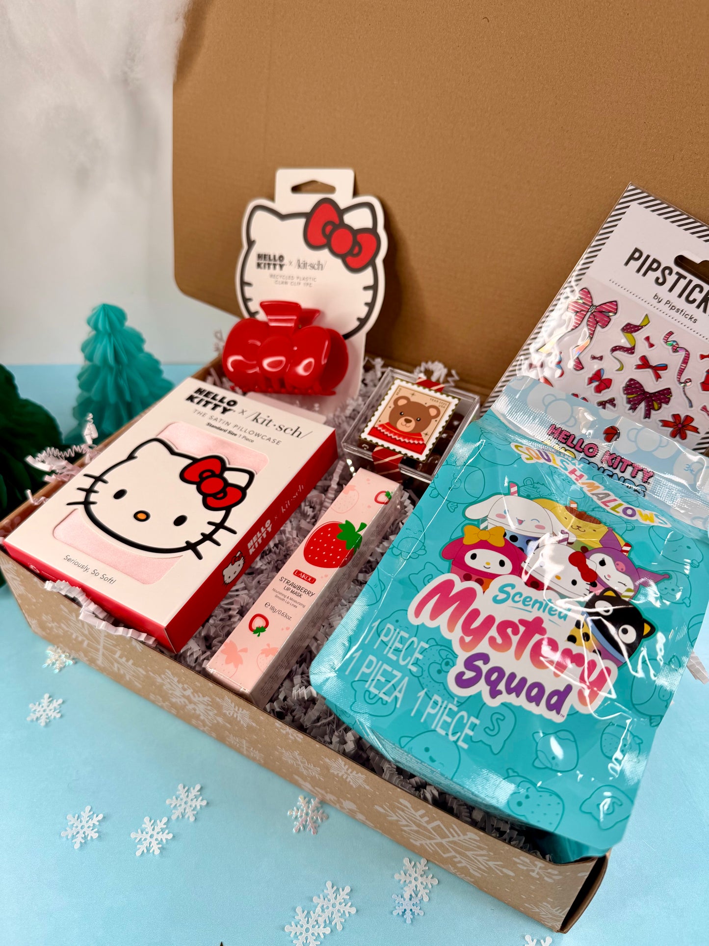 Collection of Sanrio-themed items including a Hello Kitty box and a 'Mystery Squad' pizza in a box.