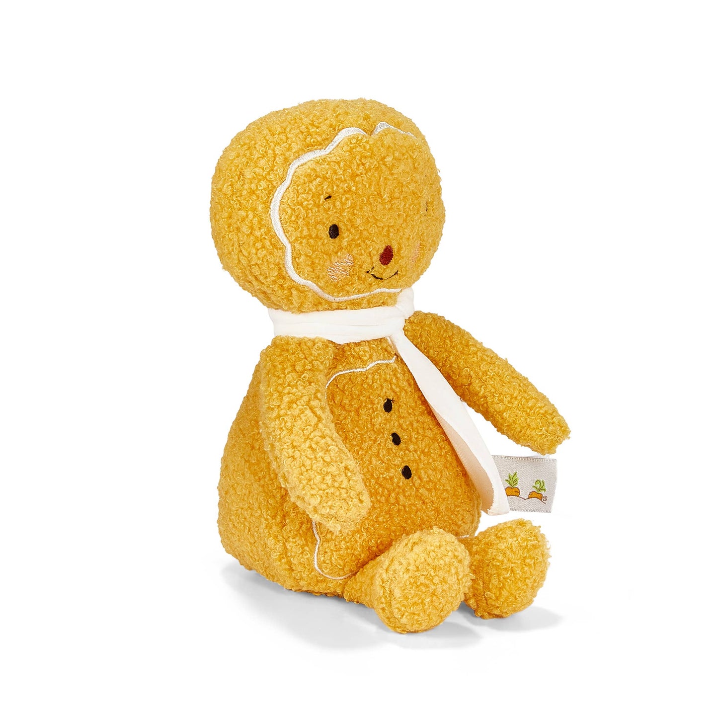 Yellow plush gingerbread man toy with a white scarf on a white background