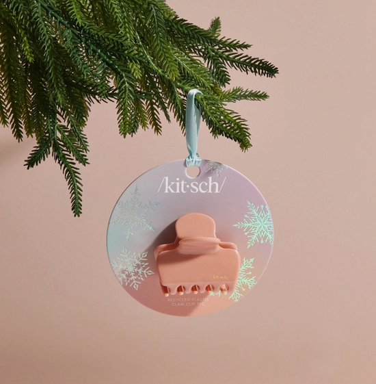 Decorative ornament with 'kitsch' branding on a pink background