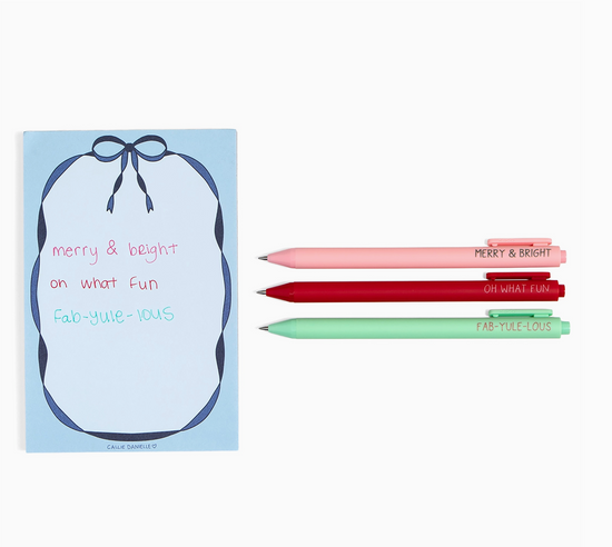 Notebook with a blue cover and three colorful pens on a white background