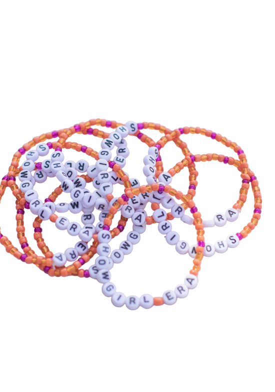 Set of colorful beaded bracelets with letter beads on a white background