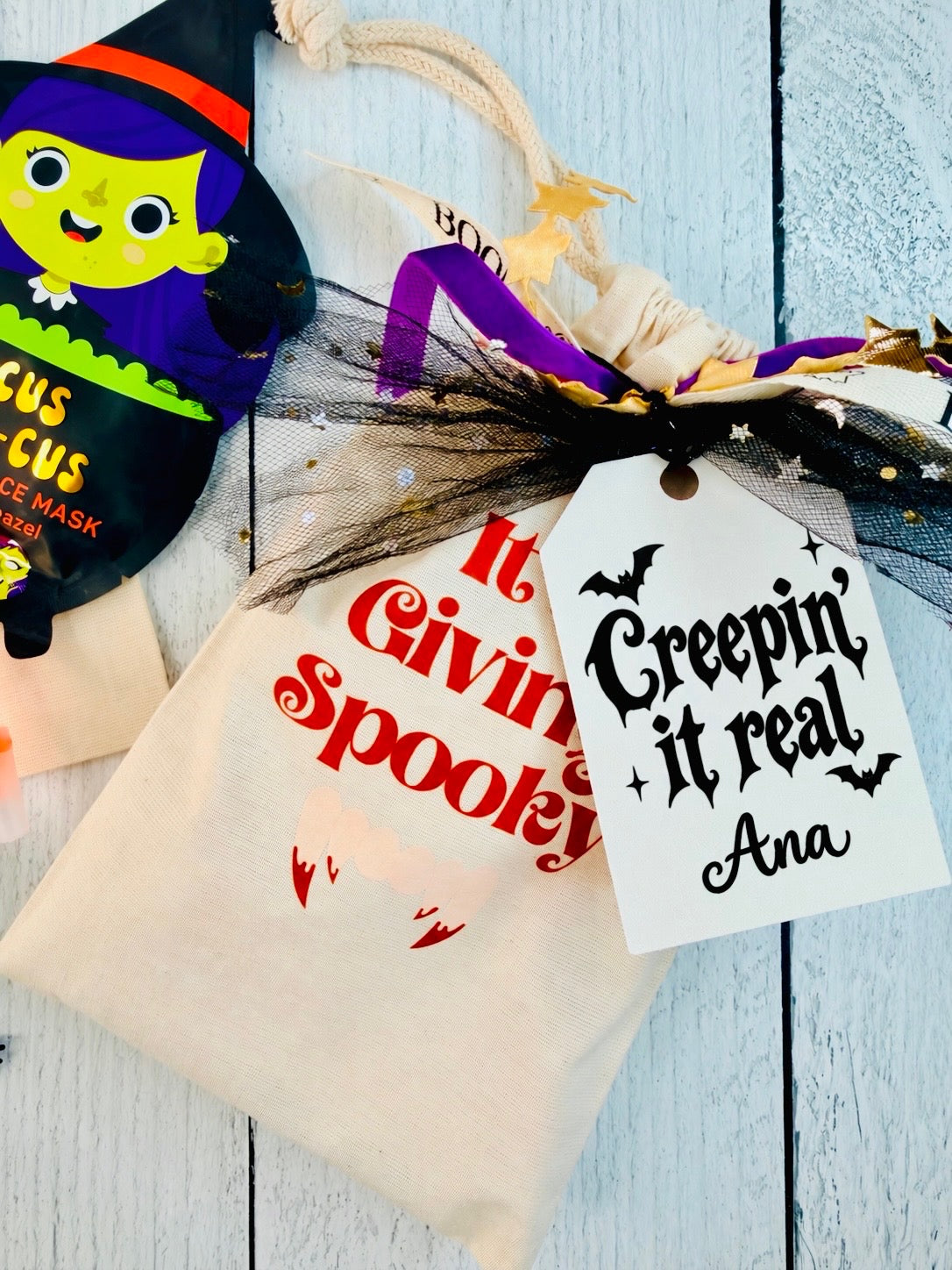 Personalized It’s Giving Spooky Bestie Boo Halloween gift bag for tweens and teens with a face mask, Boo List notepad, skeleton pen and ghost lollipop.