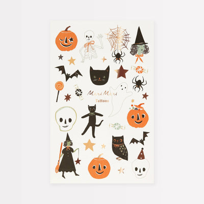 A sheet of Halloween-themed temporary tattoos featuring orange pumpkins, black cats and witches, white skulls, bats, spiders, and stars on an off-white background.