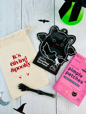 Halloween-themed products including eye patches and a pouch on a wooden surface.