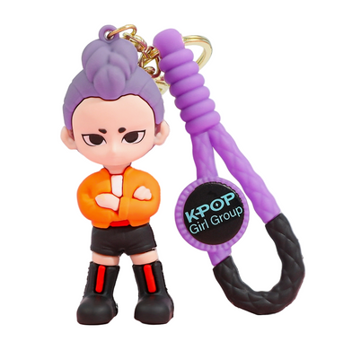 Keychain with a character figure and purple rope on a pink and blue background