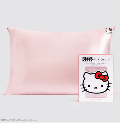 Pink satin pillowcase with Hello Kitty branding on a light gray background