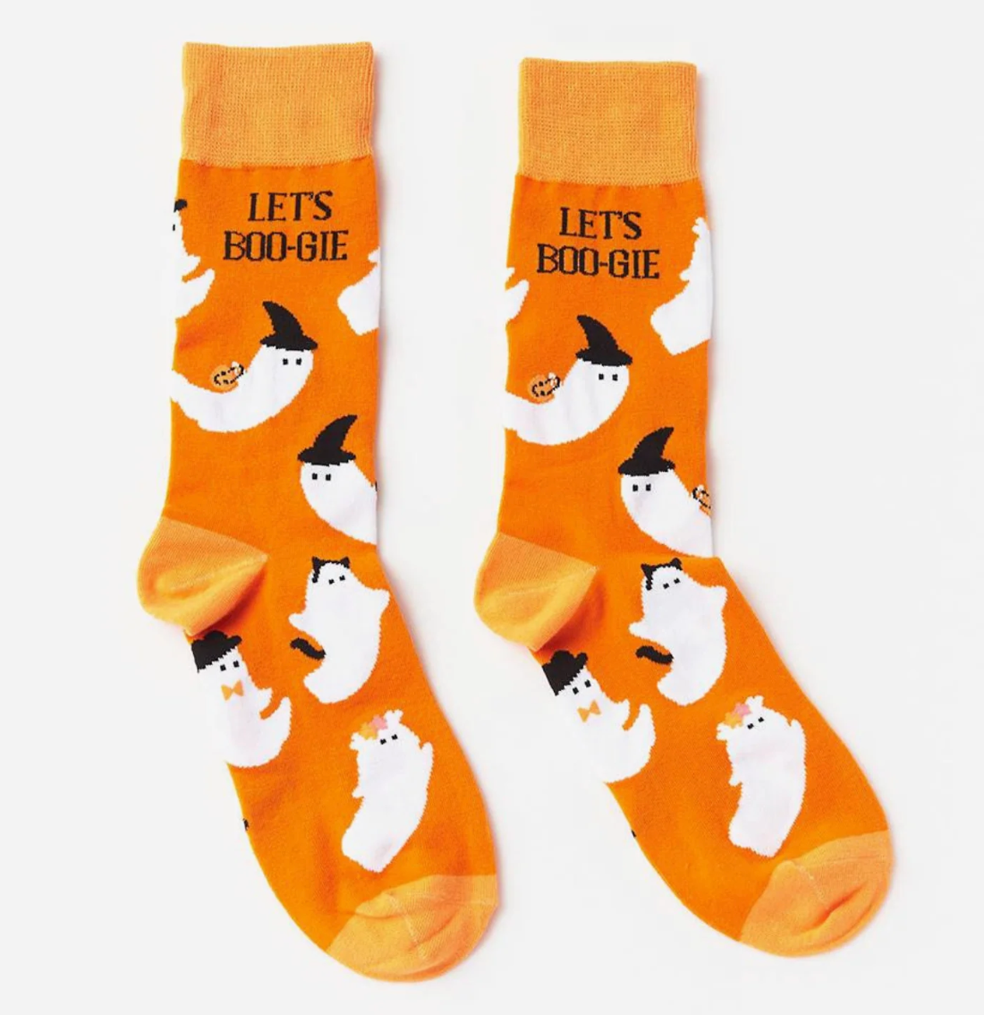 A pair of bright orange crew socks with a Halloween ghost pattern, featuring white cartoon ghosts wearing black witch hats and the text 'LET'S BOO-GIE' on the upper cuff, displayed against a clean white background.