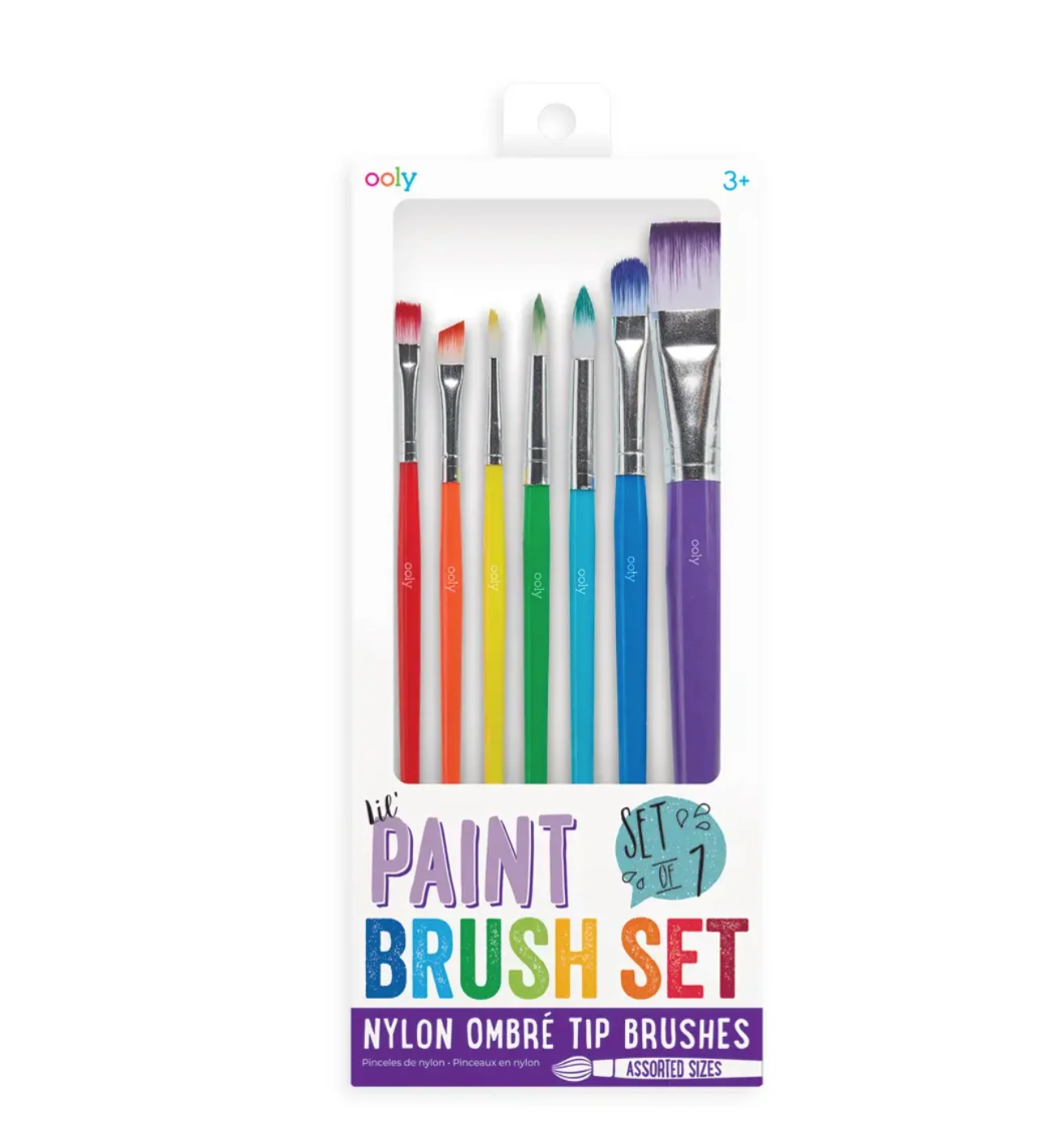 A 7-piece paint brush set in retail packaging, featuring colorful handles in red, orange, yellow, green, blue, and purple with silver nylon bristles, on a white background.