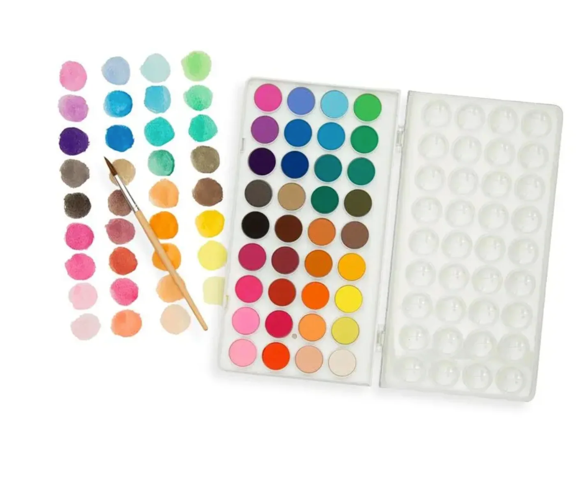 A watercolor paint palette set on a white background, featuring a 36-color watercolor paint palette, a sheet of watercolor swatches, and a wooden-handled paintbrush.