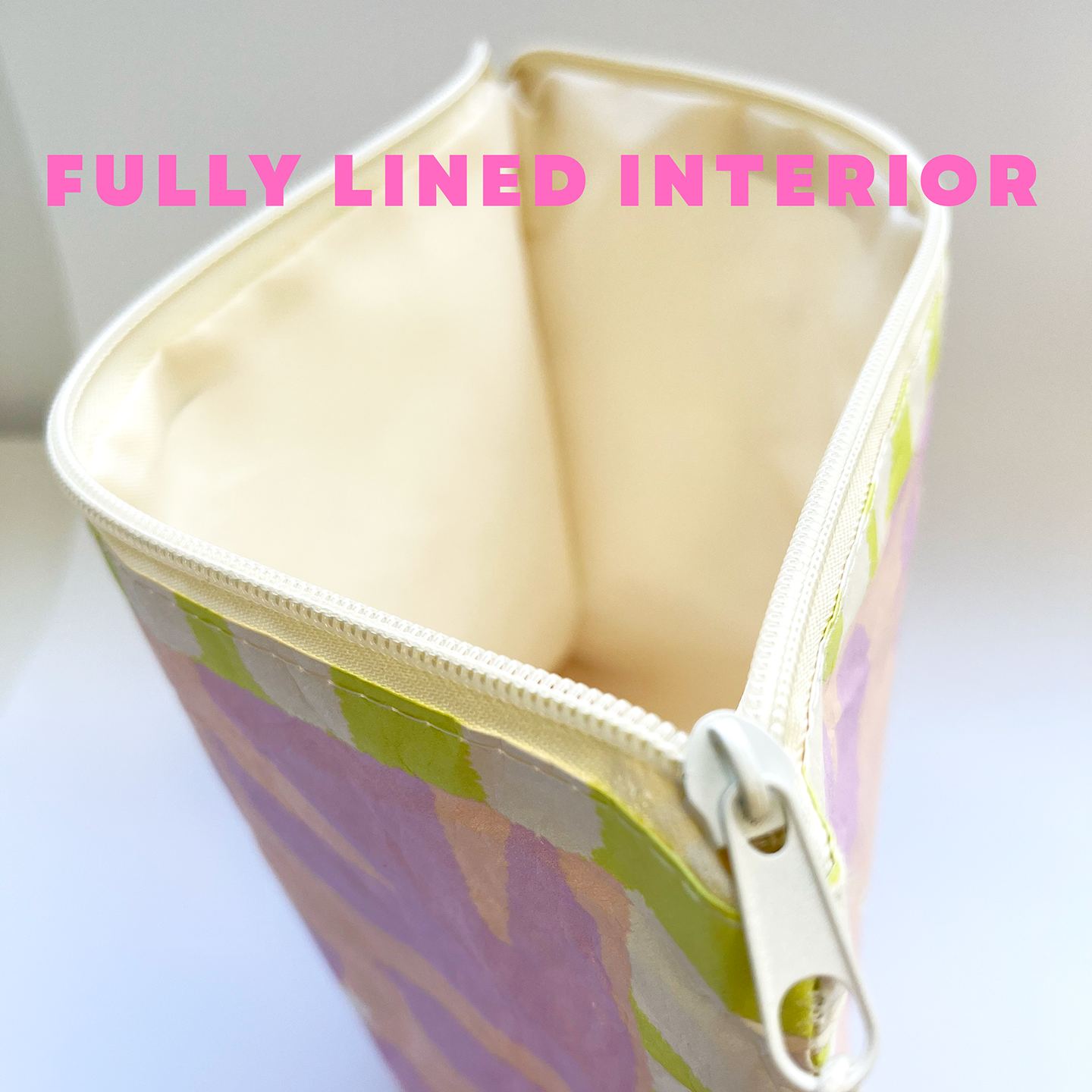 Zipper pouch with floral pattern and 'FULLY LINED INTERIOR' text on a white background