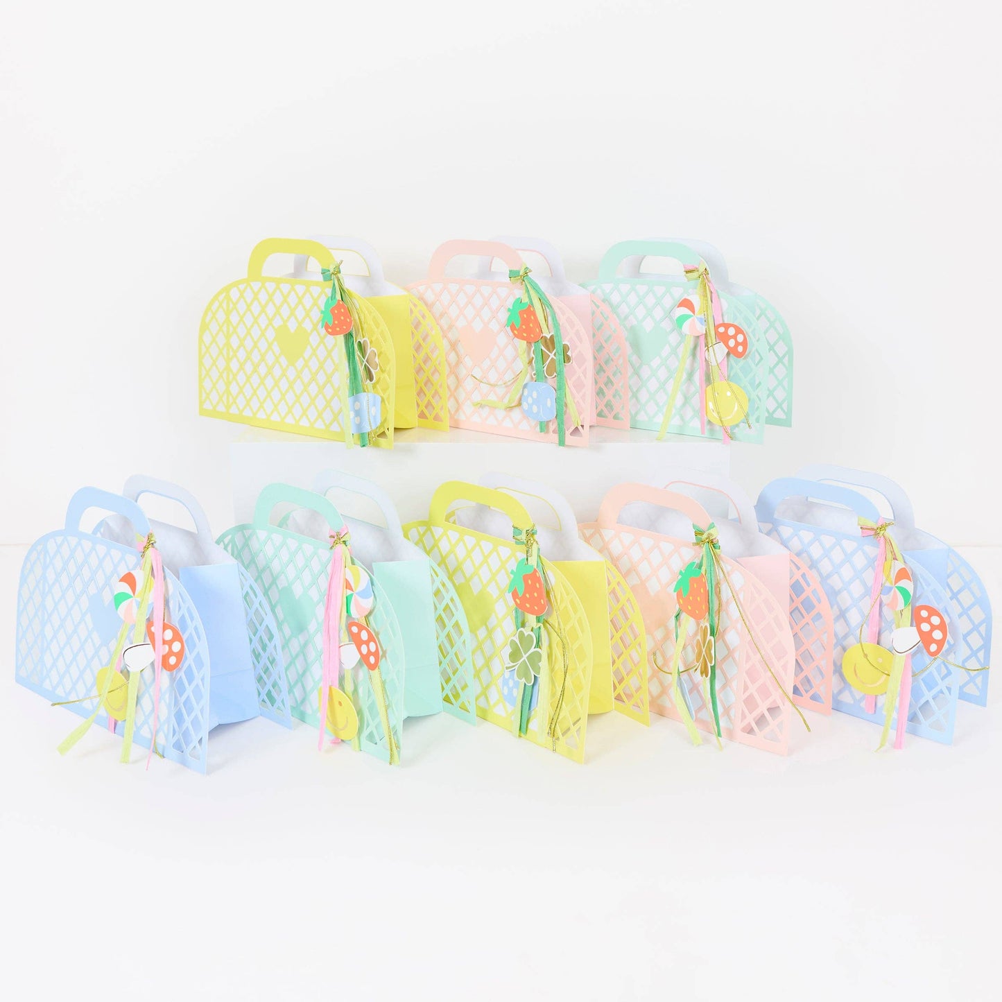 Set of colorful mesh bags with decorative handles on a white background