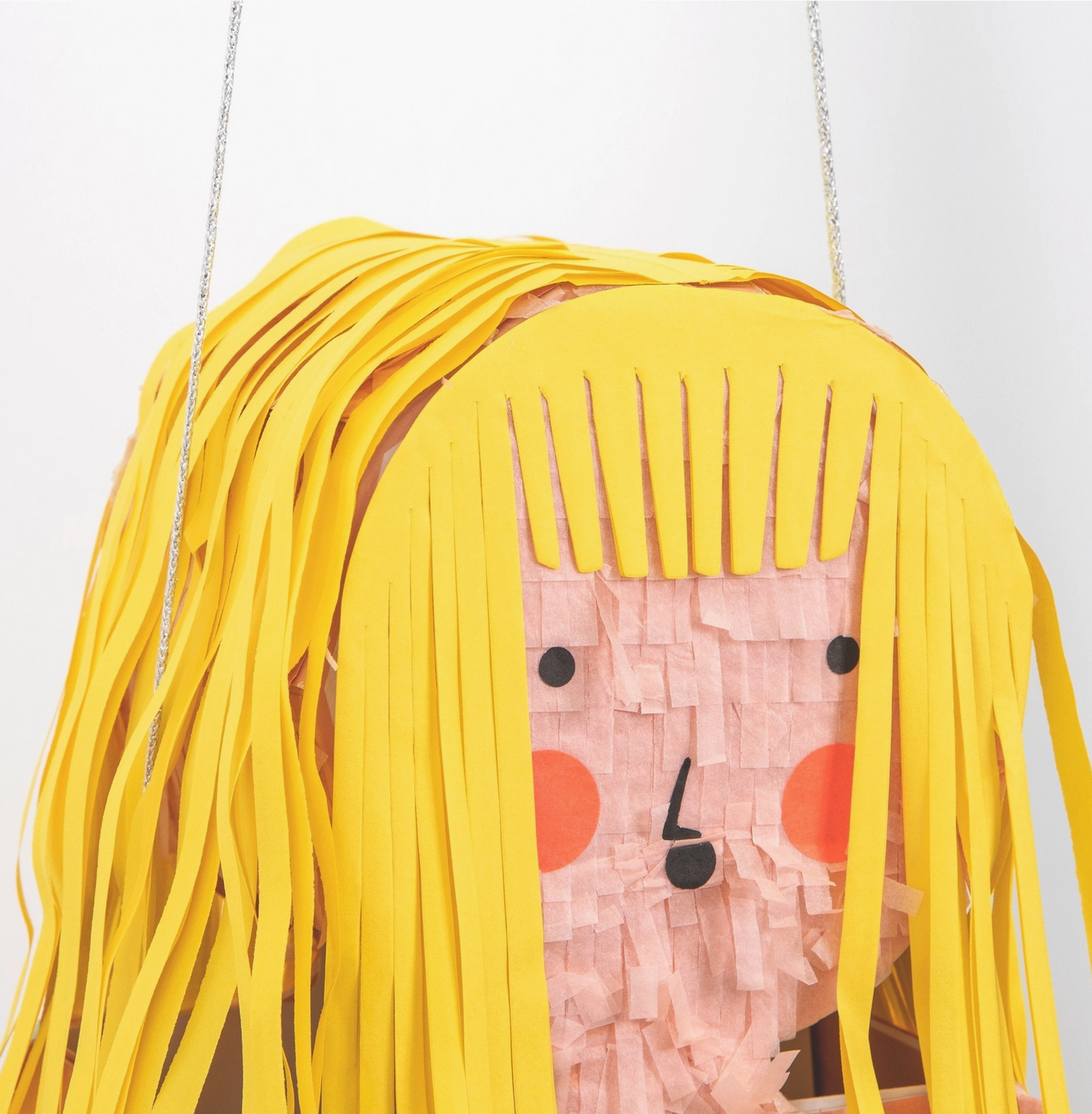 Toy figure with yellow hair and pink headband on a white background