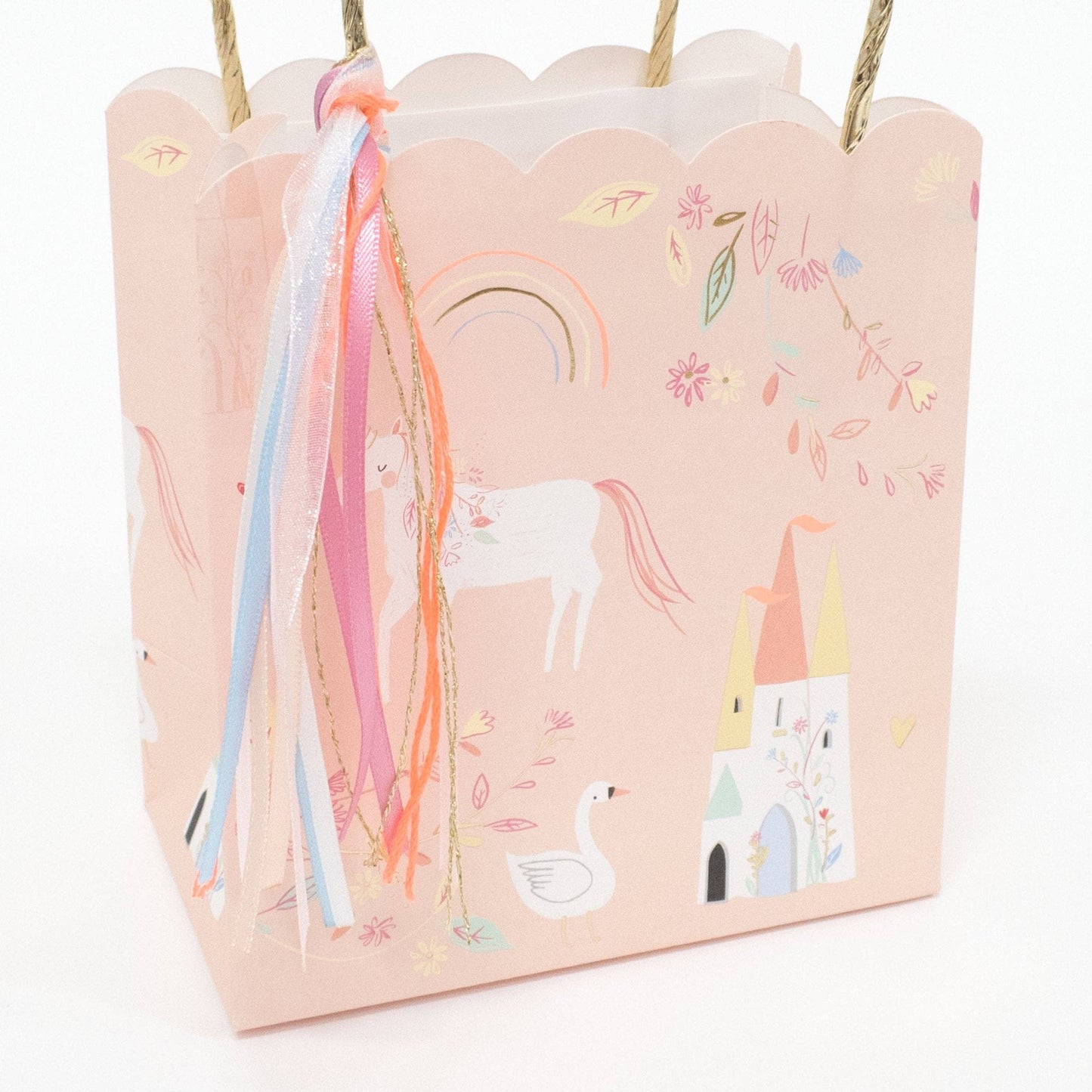 Pink gift bag with unicorn and castle designs on a white background