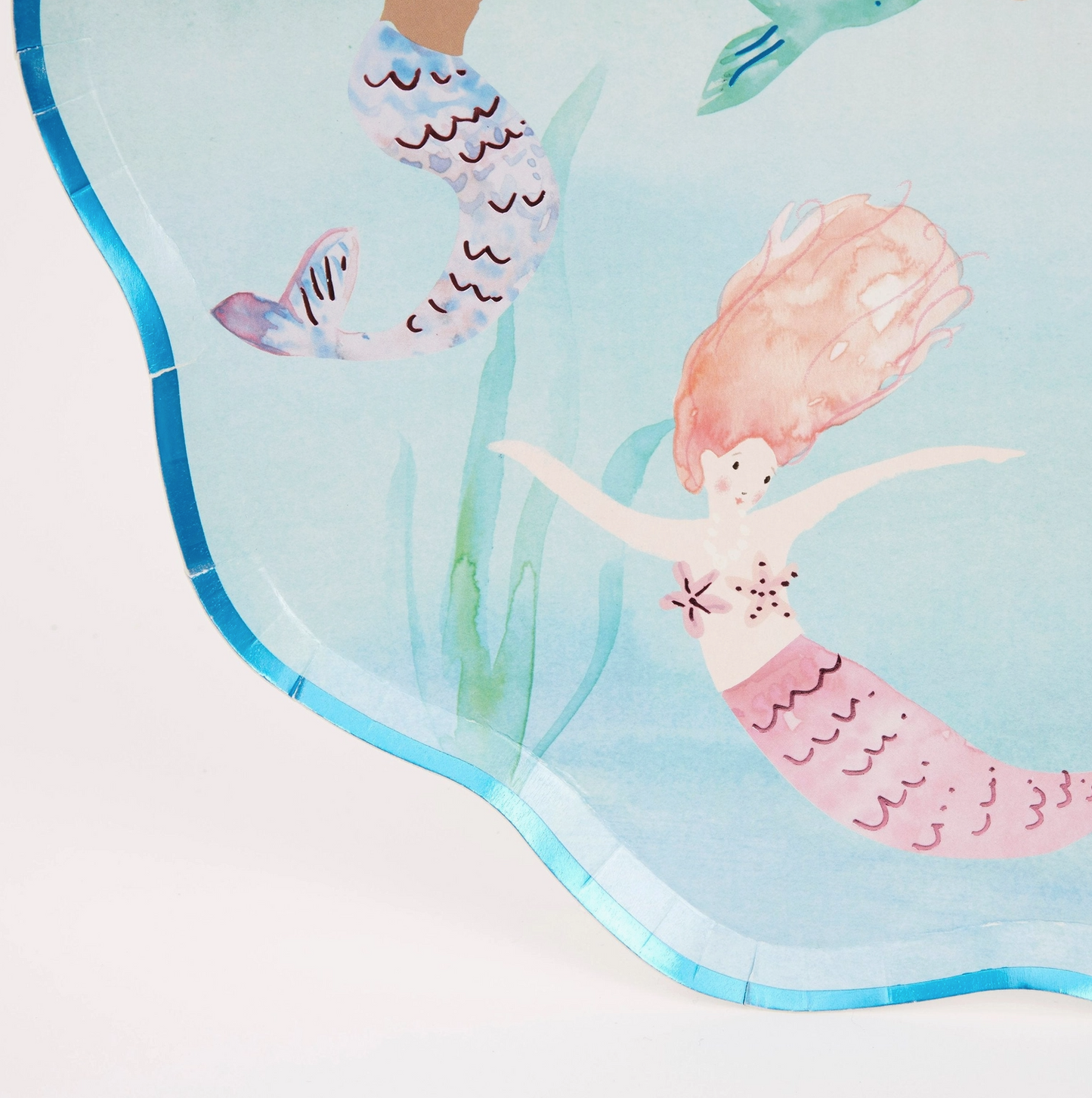 Mermaid-themed towel with mermaids and sea plants on a light blue background