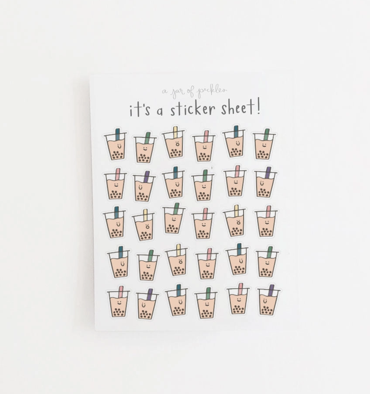 A sticker sheet featuring twenty cute illustrated boba tea cups arranged in five rows on a white background, with the text 'it's a sticker sheet!' printed above them.
