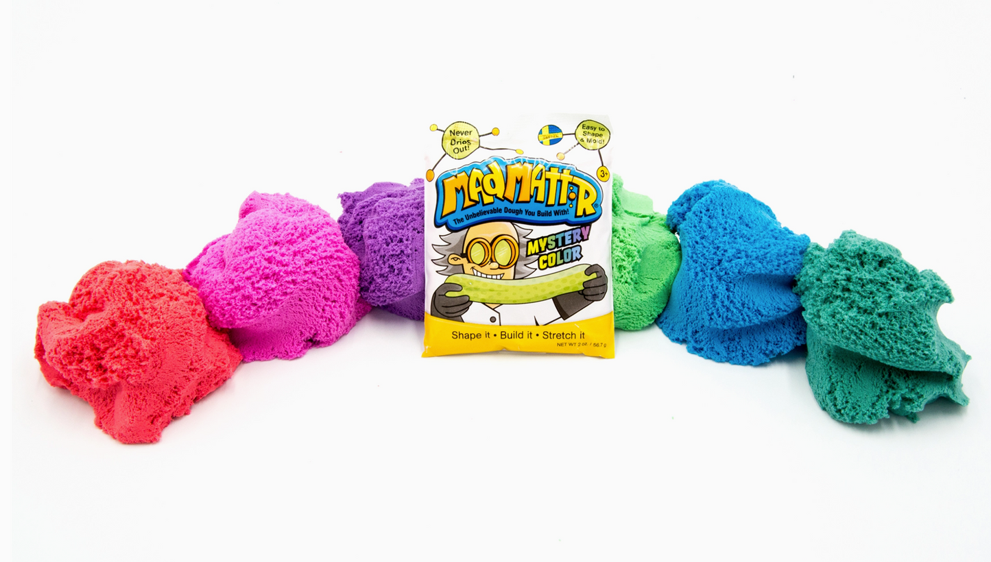 Colorful textured balls with a toy packaging labeled 'Mystery Cubes' on a white background